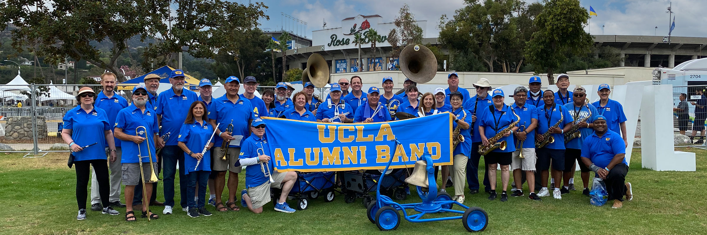 UCLA Alumni Band members standing in front of the Rose Bowl